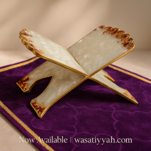 Handcrafted resin Qur'an stand with gold and ruby accents on a purple velvet mat